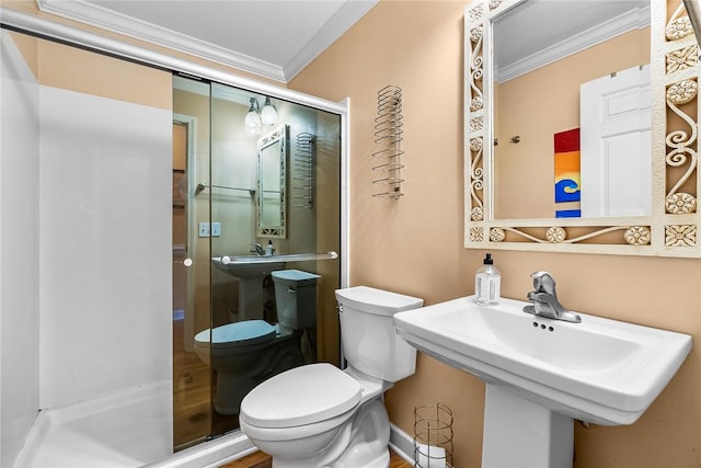 bathroom with crown molding, sink, and toilet