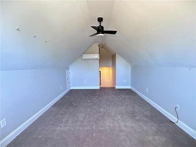 additional living space with ceiling fan, dark carpet, an AC wall unit, and vaulted ceiling