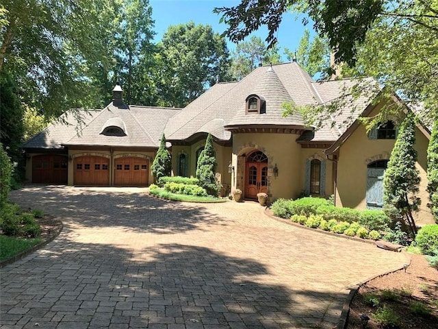 french country inspired facade with a garage