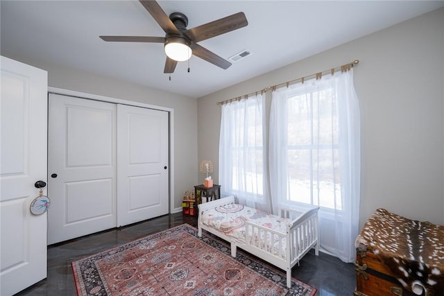 bedroom with multiple windows, a closet, and ceiling fan