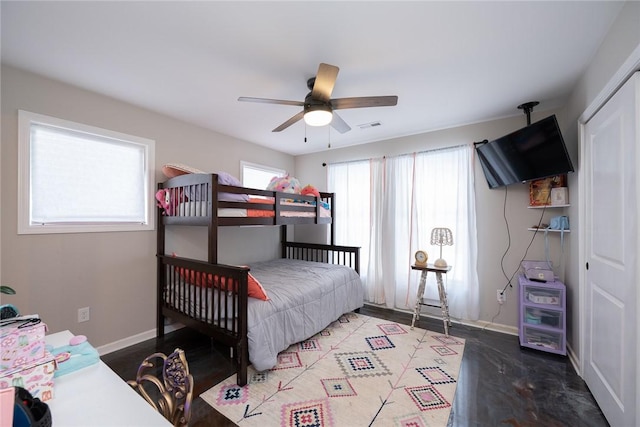 bedroom with ceiling fan and a closet