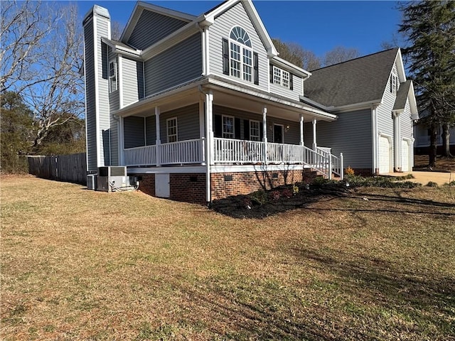 view of front facade with central AC, a garage, covered porch, and a front lawn