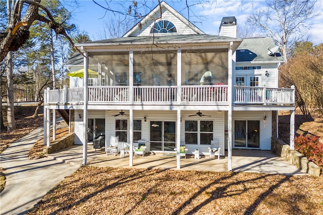 rear view of house with a patio area and a sunroom