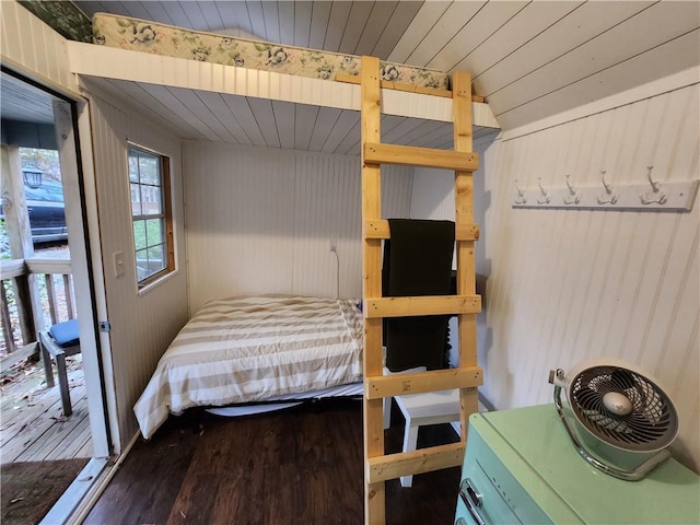 unfurnished bedroom featuring wooden walls and hardwood / wood-style flooring