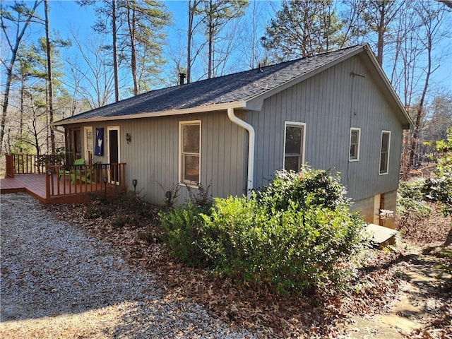 view of side of property featuring a wooden deck