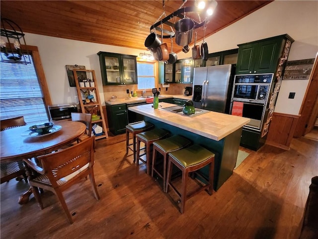 kitchen featuring wood counters, wood ceiling, stainless steel appliances, wood-type flooring, and a kitchen island