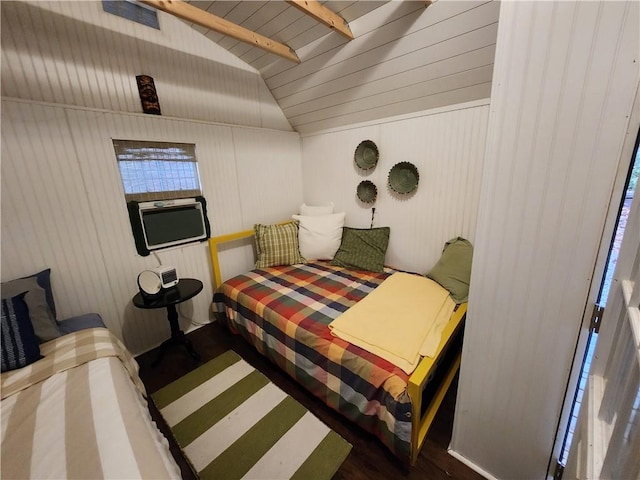 bedroom with vaulted ceiling with beams, wood walls, and dark hardwood / wood-style flooring