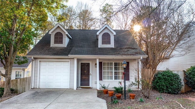 cape cod home featuring a garage