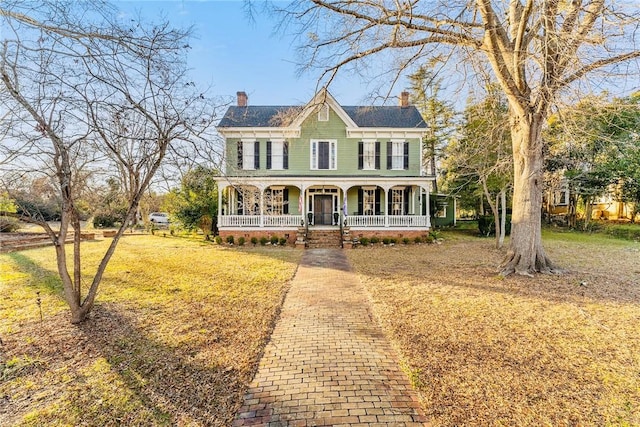 view of front of home featuring covered porch and a front lawn