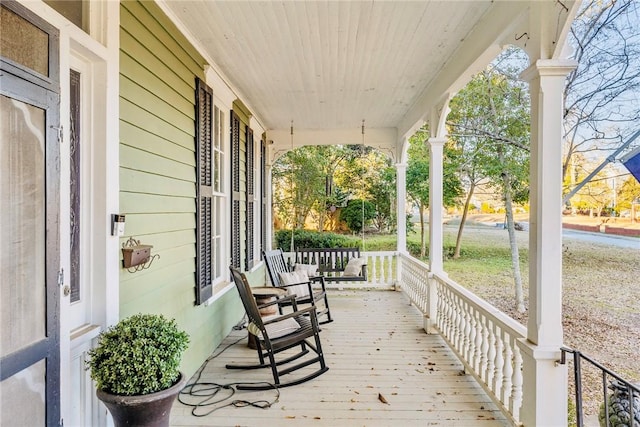 wooden terrace featuring covered porch