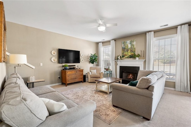 carpeted living room featuring ceiling fan