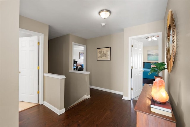 corridor with dark hardwood / wood-style flooring