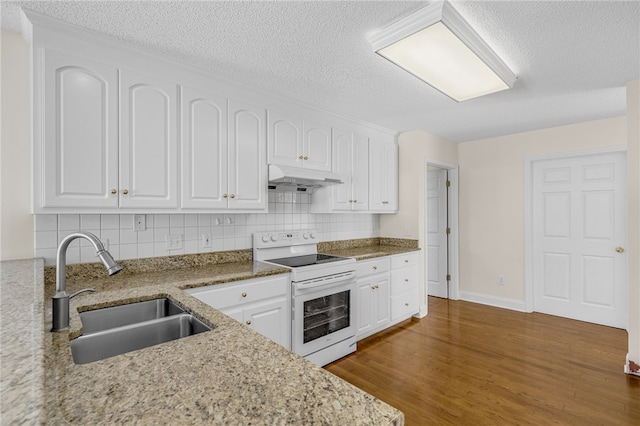 kitchen with dark hardwood / wood-style flooring, backsplash, sink, electric range, and white cabinets