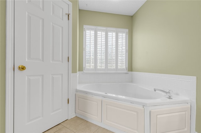 bathroom with tile patterned flooring and a washtub