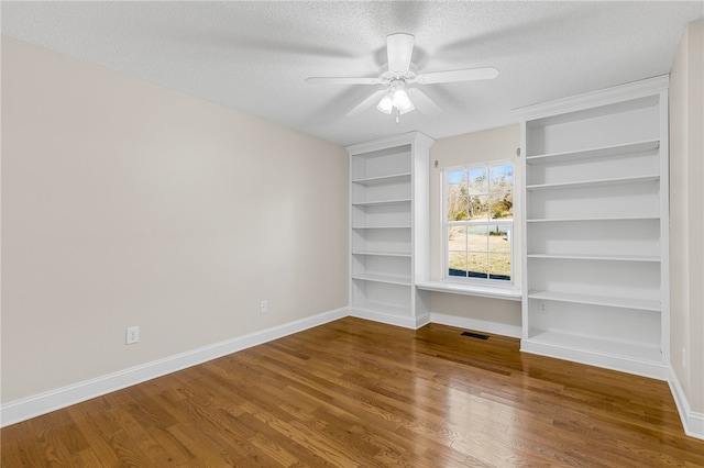 empty room with wood-type flooring, a textured ceiling, and ceiling fan