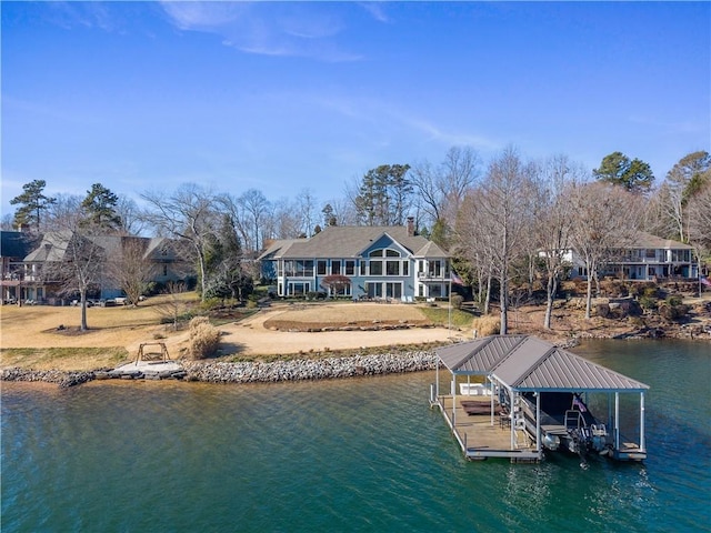 dock area with a yard and a water view