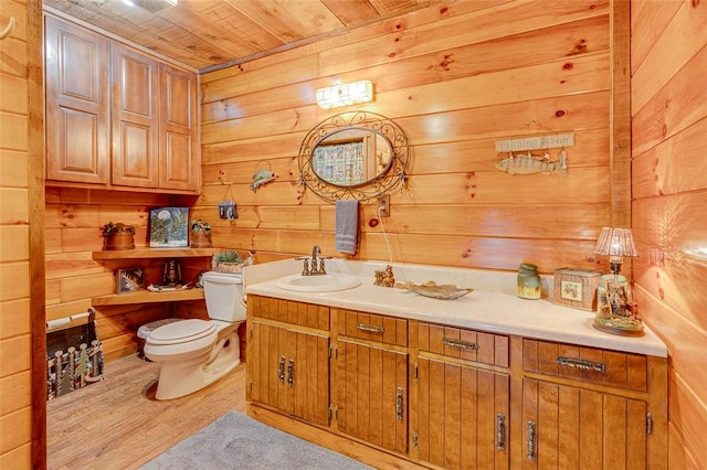 bathroom featuring hardwood / wood-style floors, wood ceiling, vanity, toilet, and wood walls