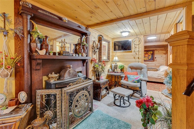 living area featuring carpet, wood ceiling, and wooden walls