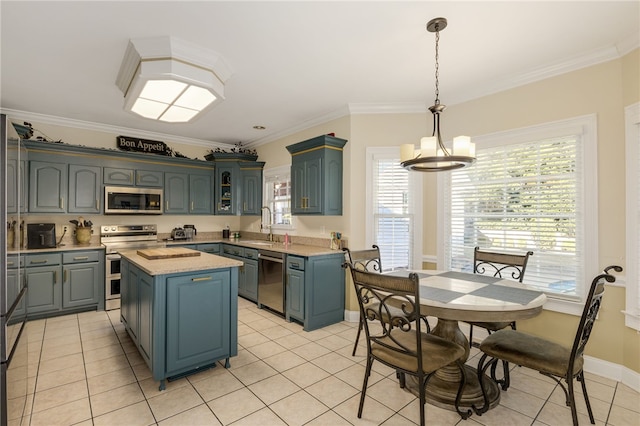 kitchen with decorative light fixtures, a center island, crown molding, stainless steel appliances, and light tile patterned floors