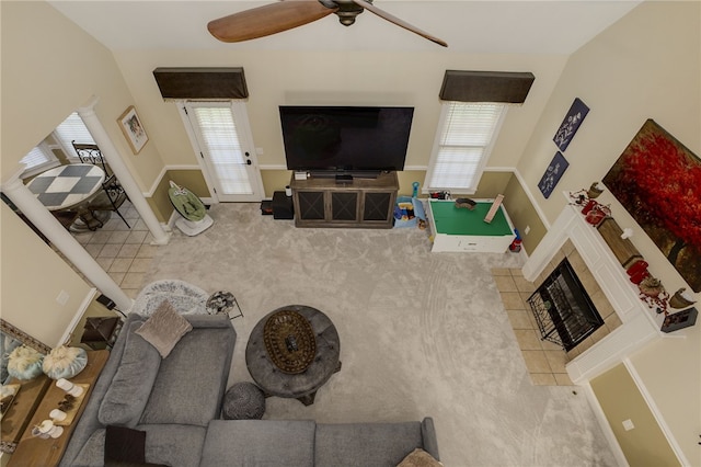 carpeted living room featuring ceiling fan, a healthy amount of sunlight, and a fireplace