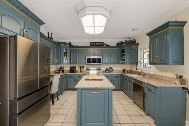 kitchen with a kitchen island, stainless steel appliances, sink, light tile patterned flooring, and crown molding