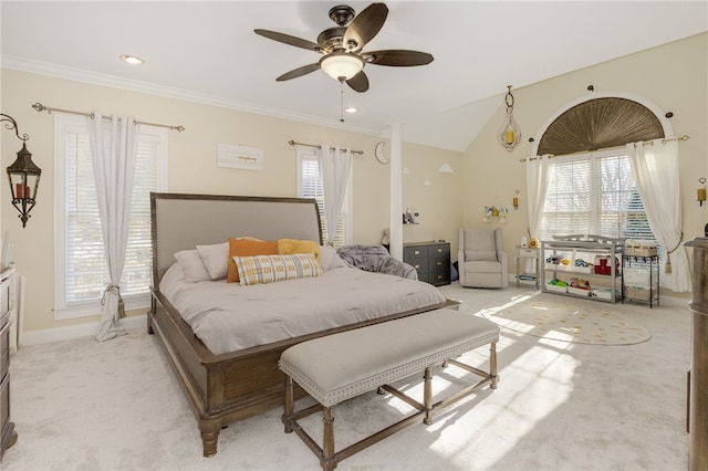 carpeted bedroom featuring ceiling fan, crown molding, and vaulted ceiling