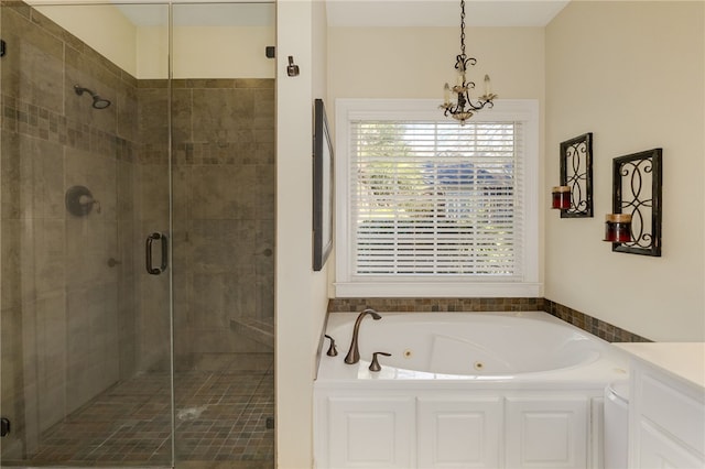 bathroom with a chandelier, shower with separate bathtub, and vanity