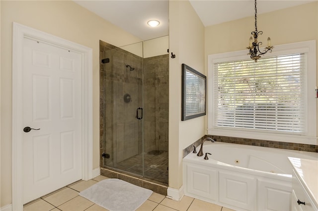 bathroom featuring plus walk in shower, an inviting chandelier, and tile patterned flooring