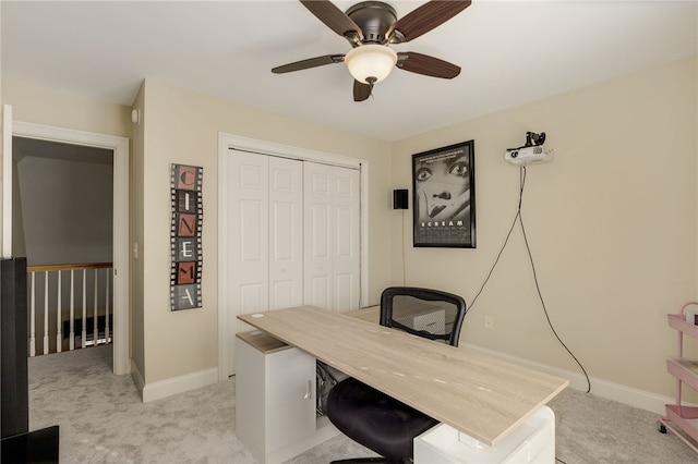 carpeted home office with ceiling fan