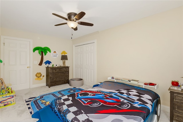 bedroom featuring ceiling fan, light colored carpet, and a closet