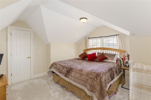 carpeted bedroom featuring lofted ceiling