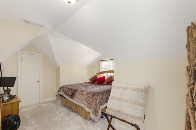 carpeted bedroom featuring lofted ceiling