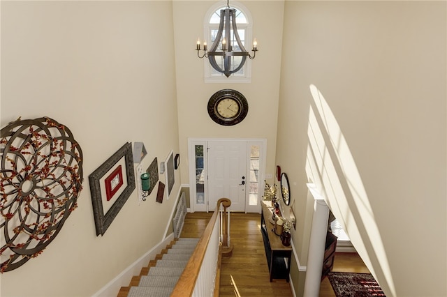 foyer featuring a notable chandelier, a high ceiling, and dark hardwood / wood-style floors