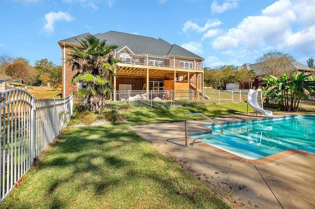 view of swimming pool featuring a water slide and a patio