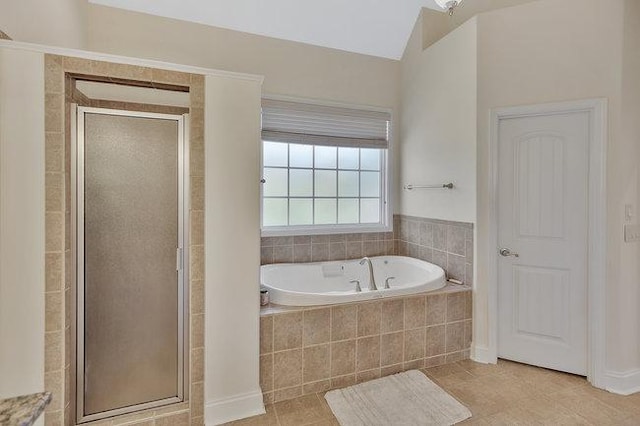 bathroom featuring tile patterned flooring and independent shower and bath