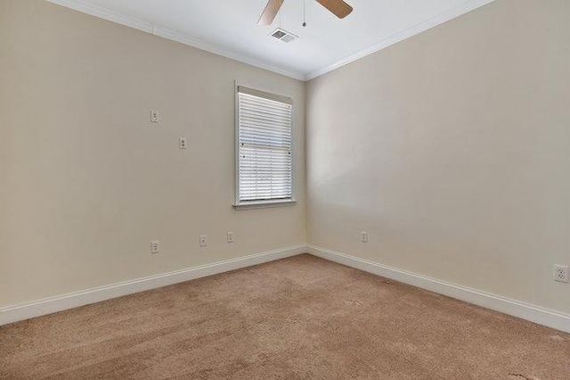 spare room with ceiling fan, light colored carpet, and ornamental molding