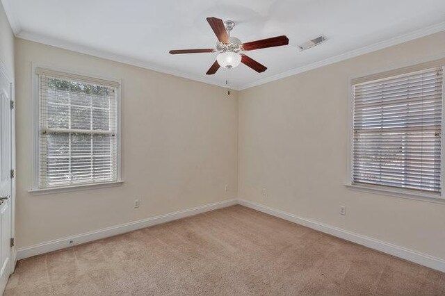 carpeted empty room featuring ceiling fan and ornamental molding