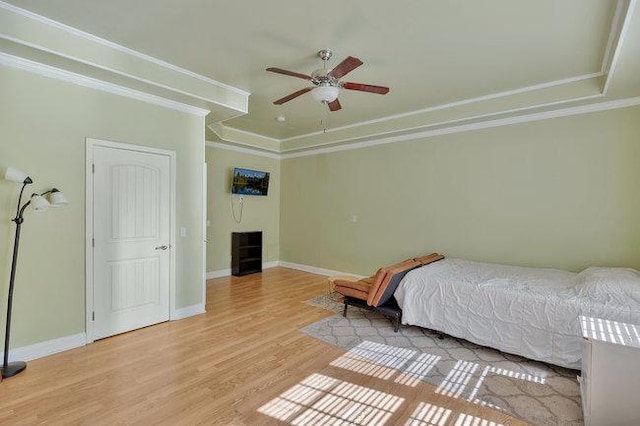 bedroom with ceiling fan, light wood-type flooring, and ornamental molding