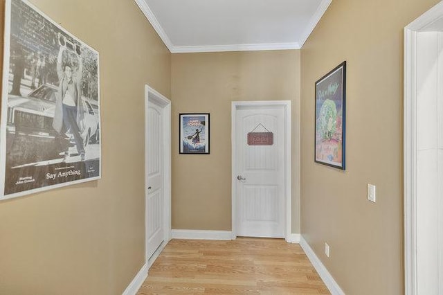 hallway with ornamental molding and light wood-type flooring