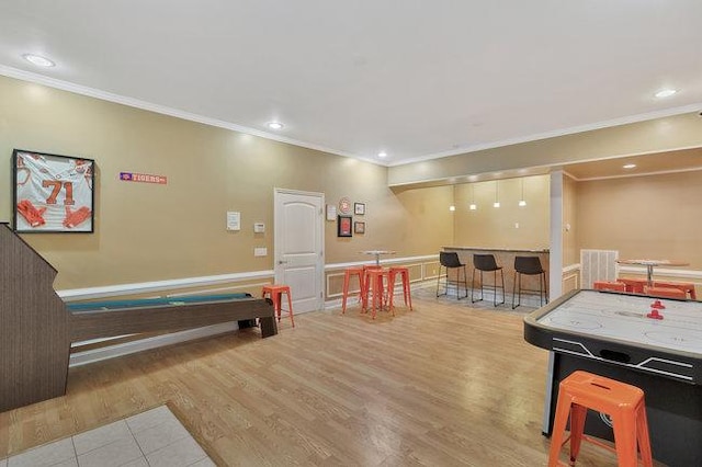 recreation room featuring light hardwood / wood-style floors, ornamental molding, and billiards