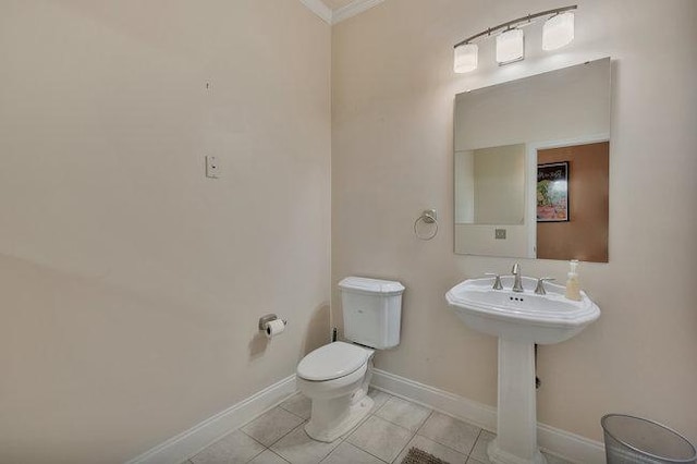 bathroom with tile patterned flooring, sink, toilet, and crown molding