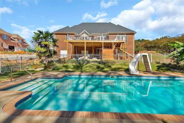 view of swimming pool featuring a patio area and a water slide