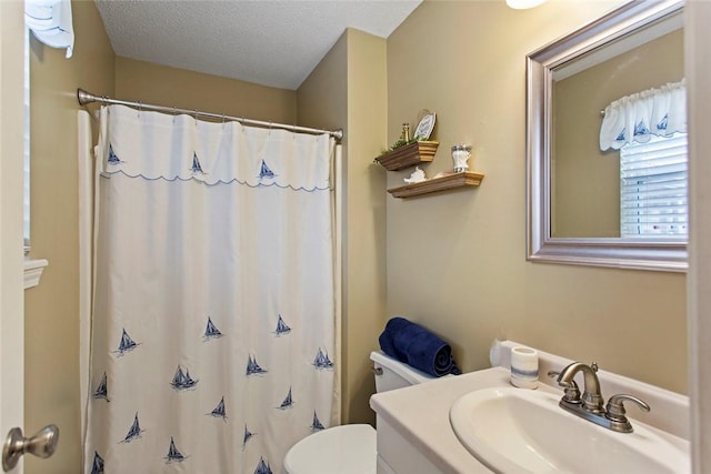 bathroom featuring toilet, a shower with curtain, a textured ceiling, and vanity