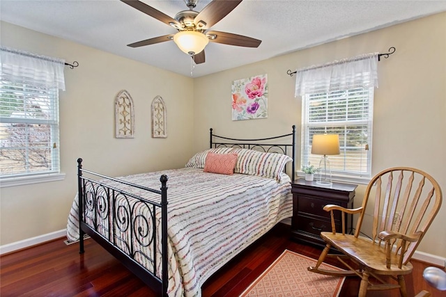 bedroom featuring a ceiling fan, baseboards, and wood finished floors