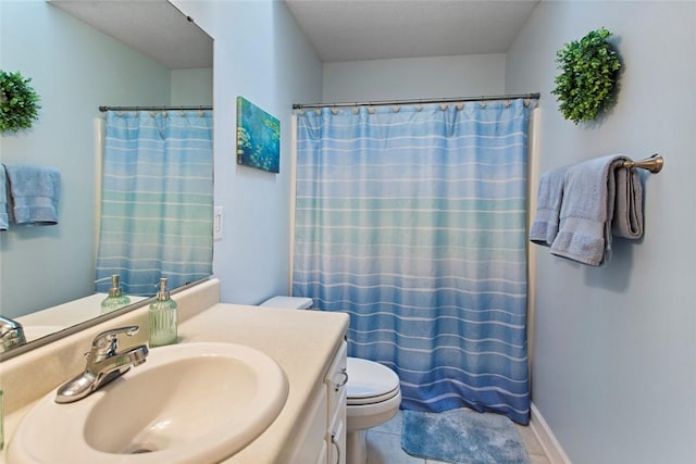 full bath featuring baseboards, vanity, toilet, and tile patterned floors