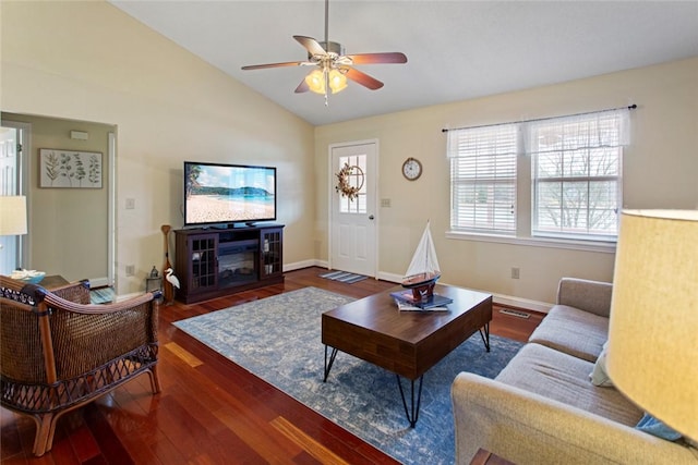 living room with a ceiling fan, lofted ceiling, baseboards, and wood finished floors