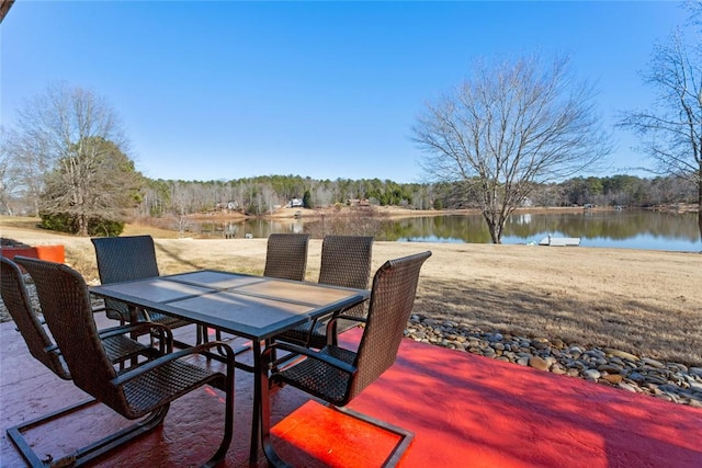 view of patio / terrace with a water view and outdoor dining area