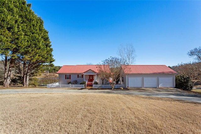 ranch-style home featuring covered porch, concrete driveway, an attached garage, a front yard, and fence