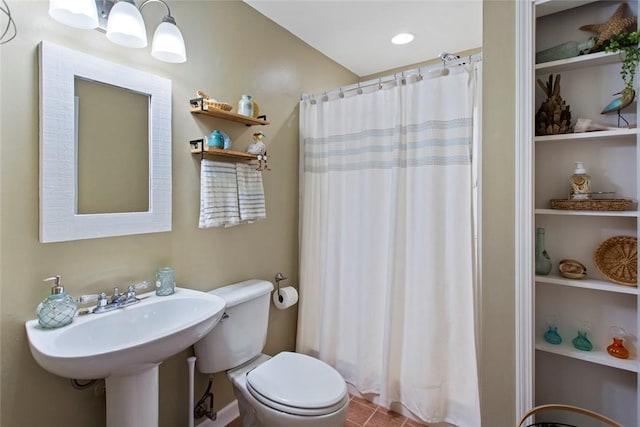 bathroom with built in shelves, a sink, toilet, and a shower with curtain