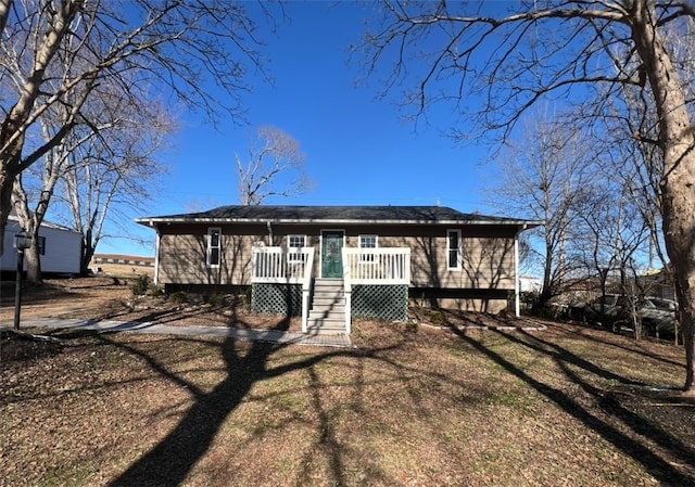 view of front of property with a deck and a front yard